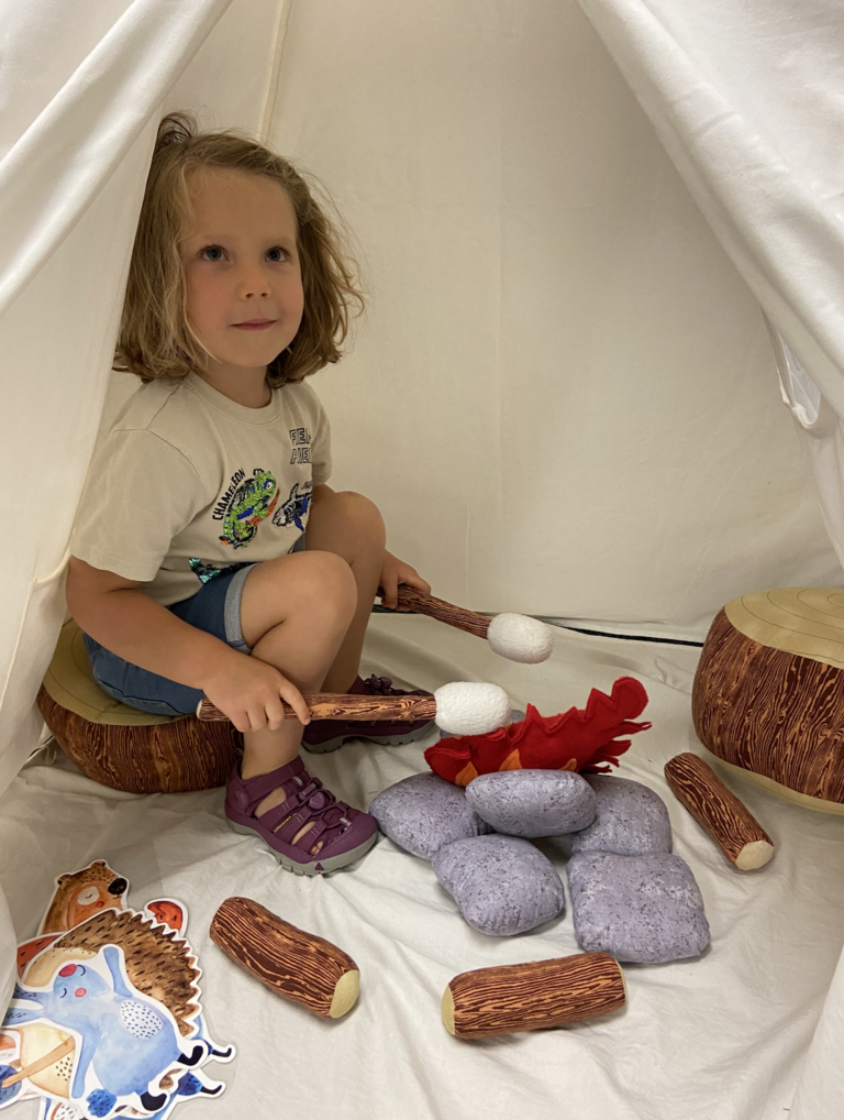 child playing in a tent