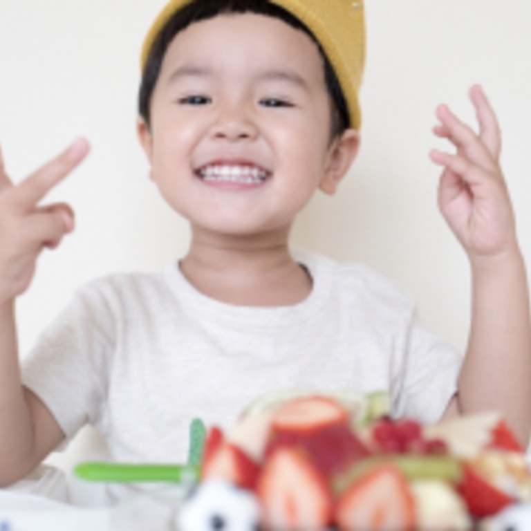 Smiling child with raised hands