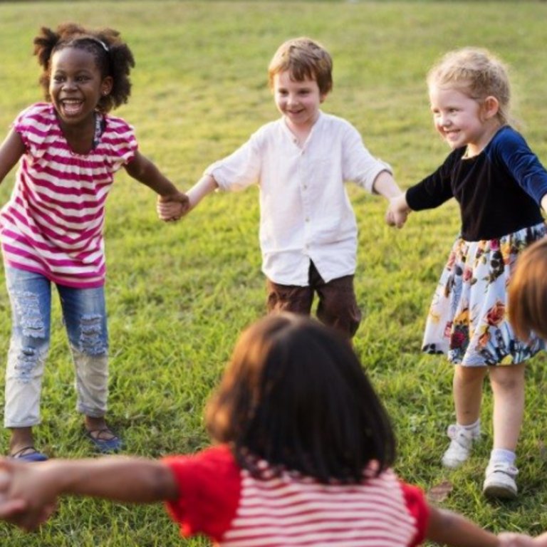 children standing in a circle holding hands
