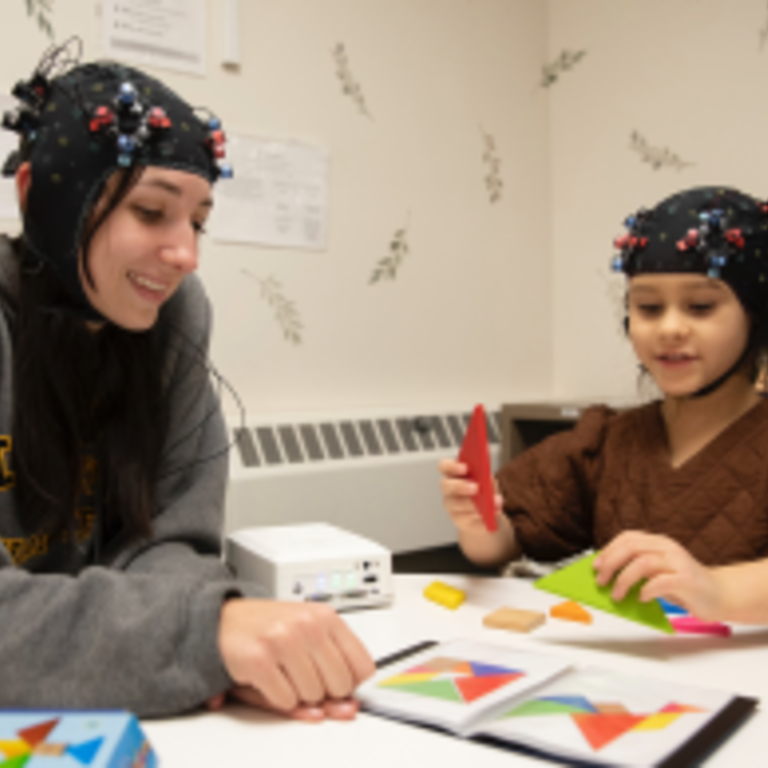 student working with child in the lab